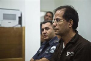 Iranian-Belgian citizen Ali Mansouri sits in a courtroom at court in Petah Tikva